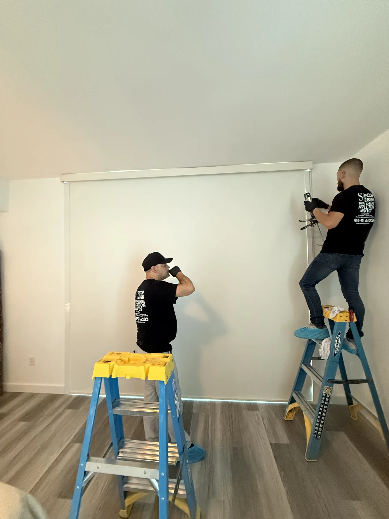 S&V Decor Design installers mounting a roller shade for a contractor project