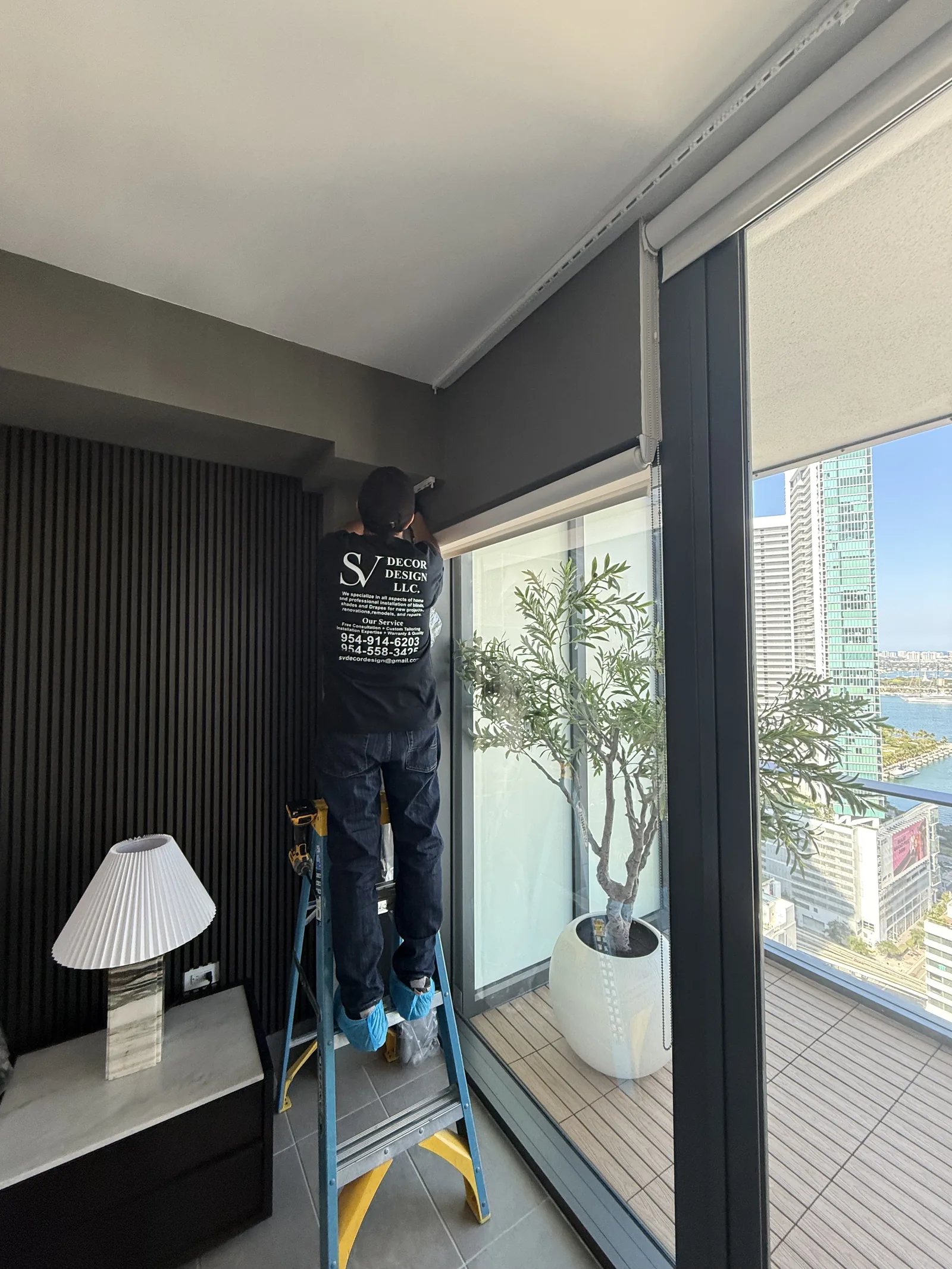 S&V Decor Design installer fitting a shade on a job site
