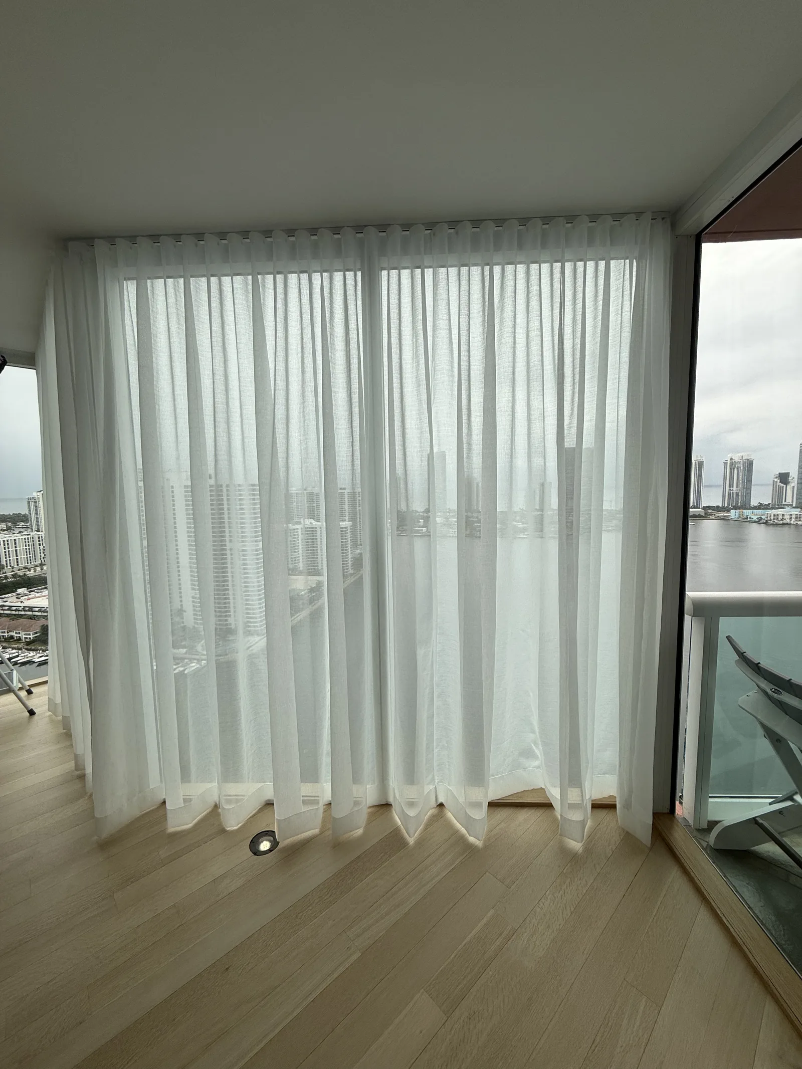 Sheer drapery with a balcony view