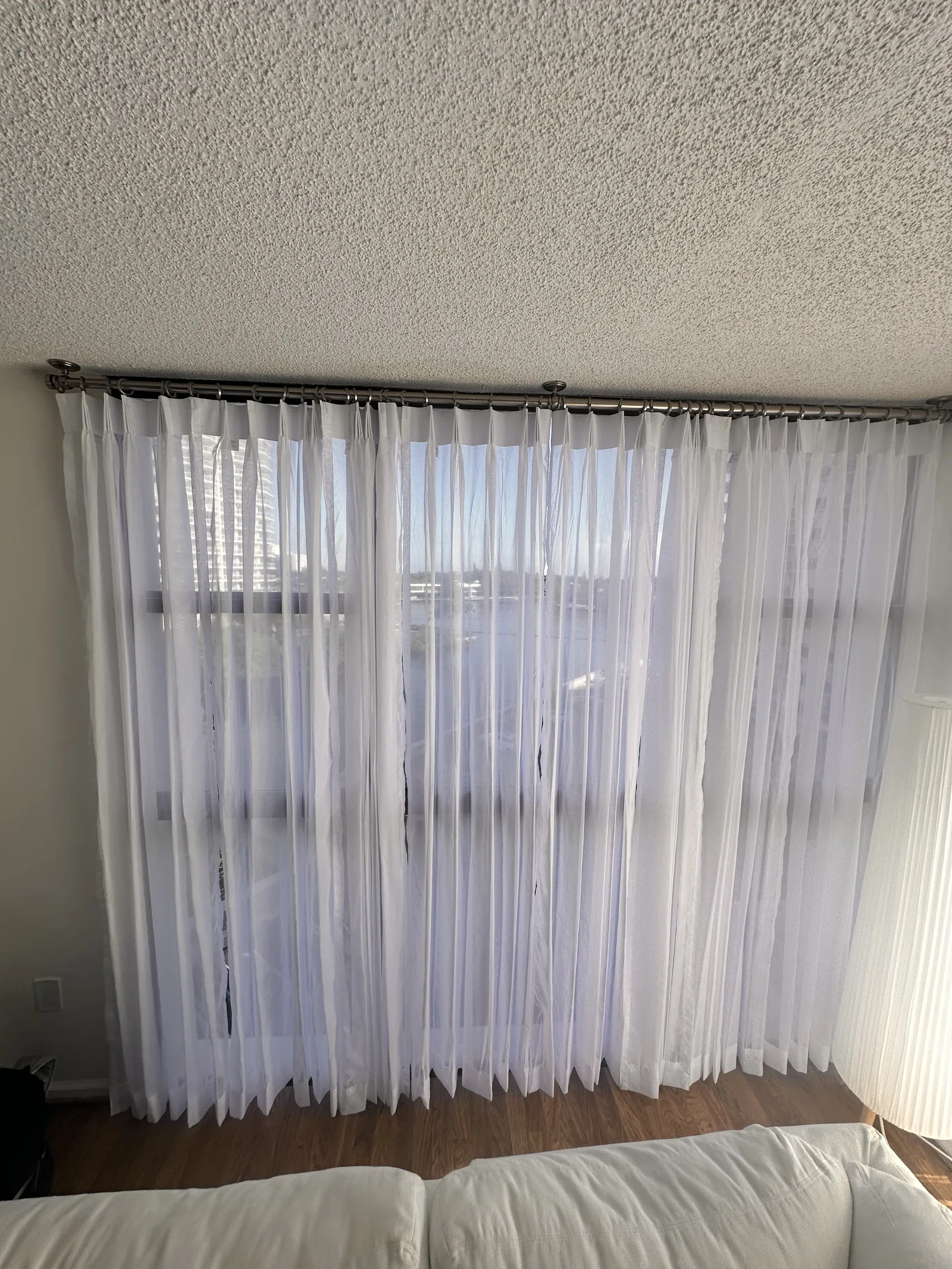 Sheer drapery gathered at a bedroom window