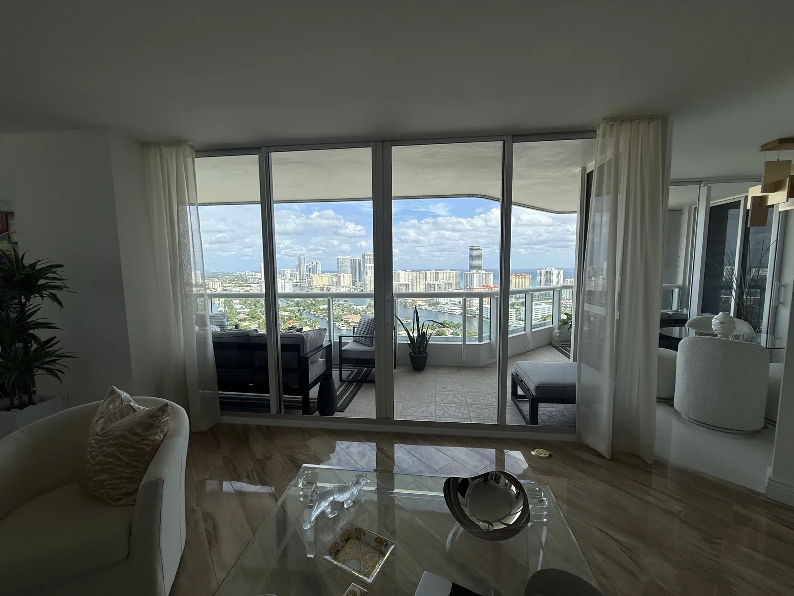 Sheer drapery in a living room with a city skyline view