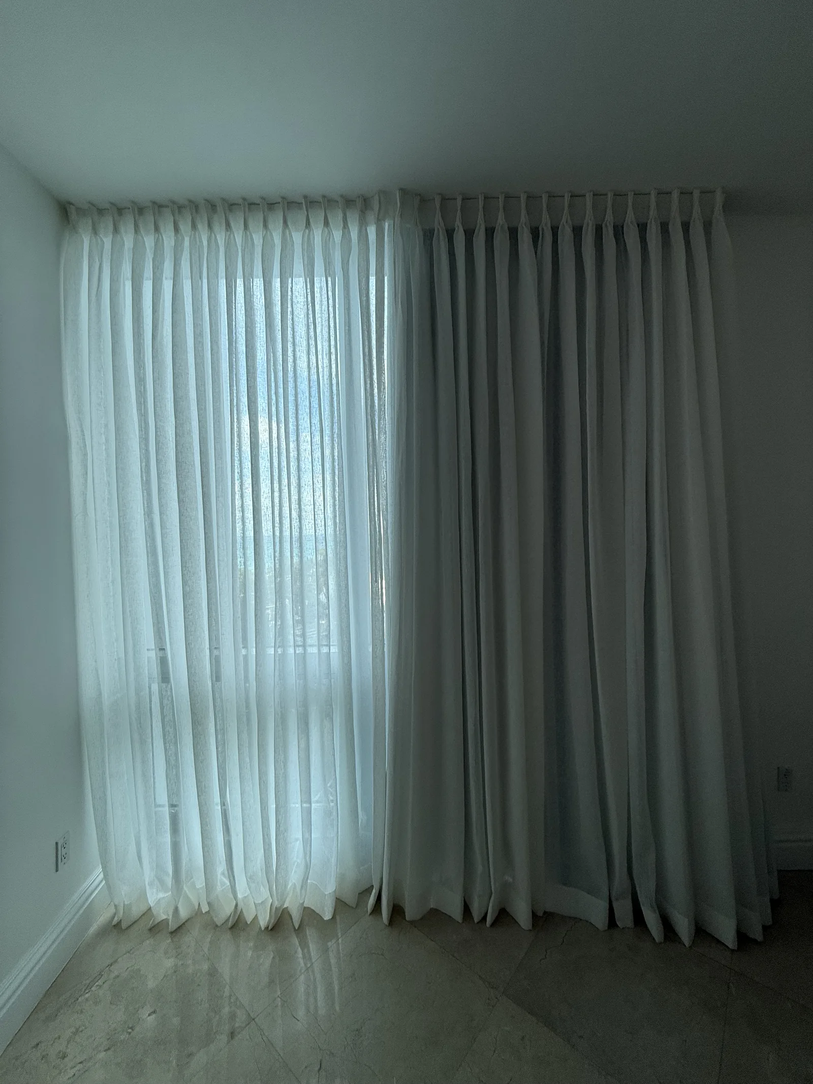Floor-length sheer drapery filling a wall of windows