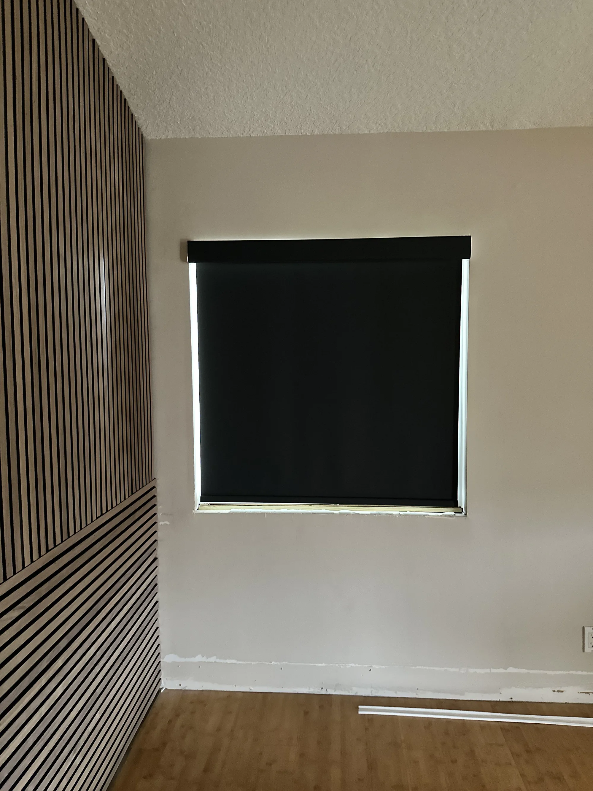Fully opaque blackout roller shade in a modern bedroom