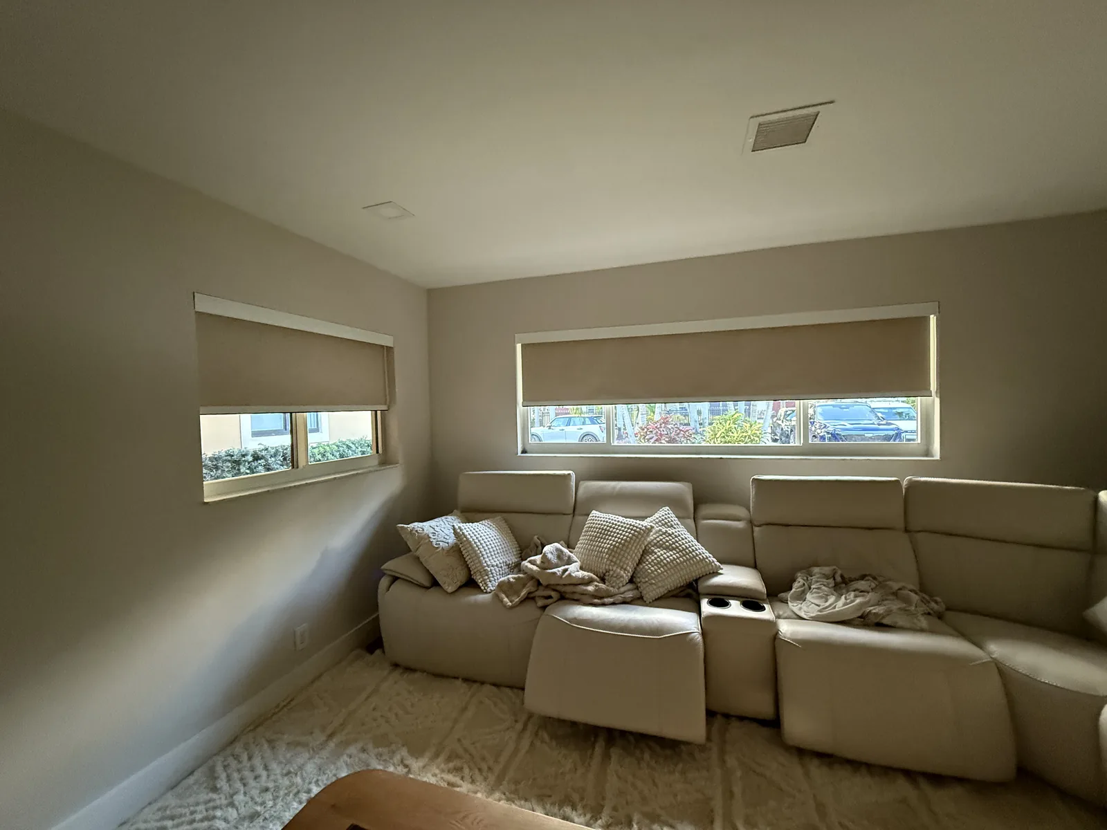 Blackout roller shades in a media room with a sectional