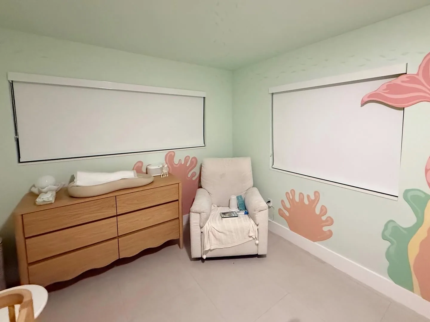 Blackout roller shades in a children's room with a painted mural