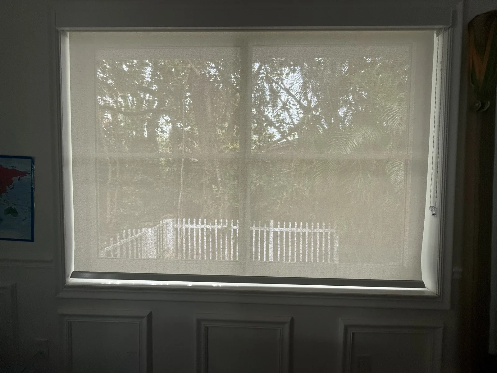 Light-filtering roller shade over a garden window