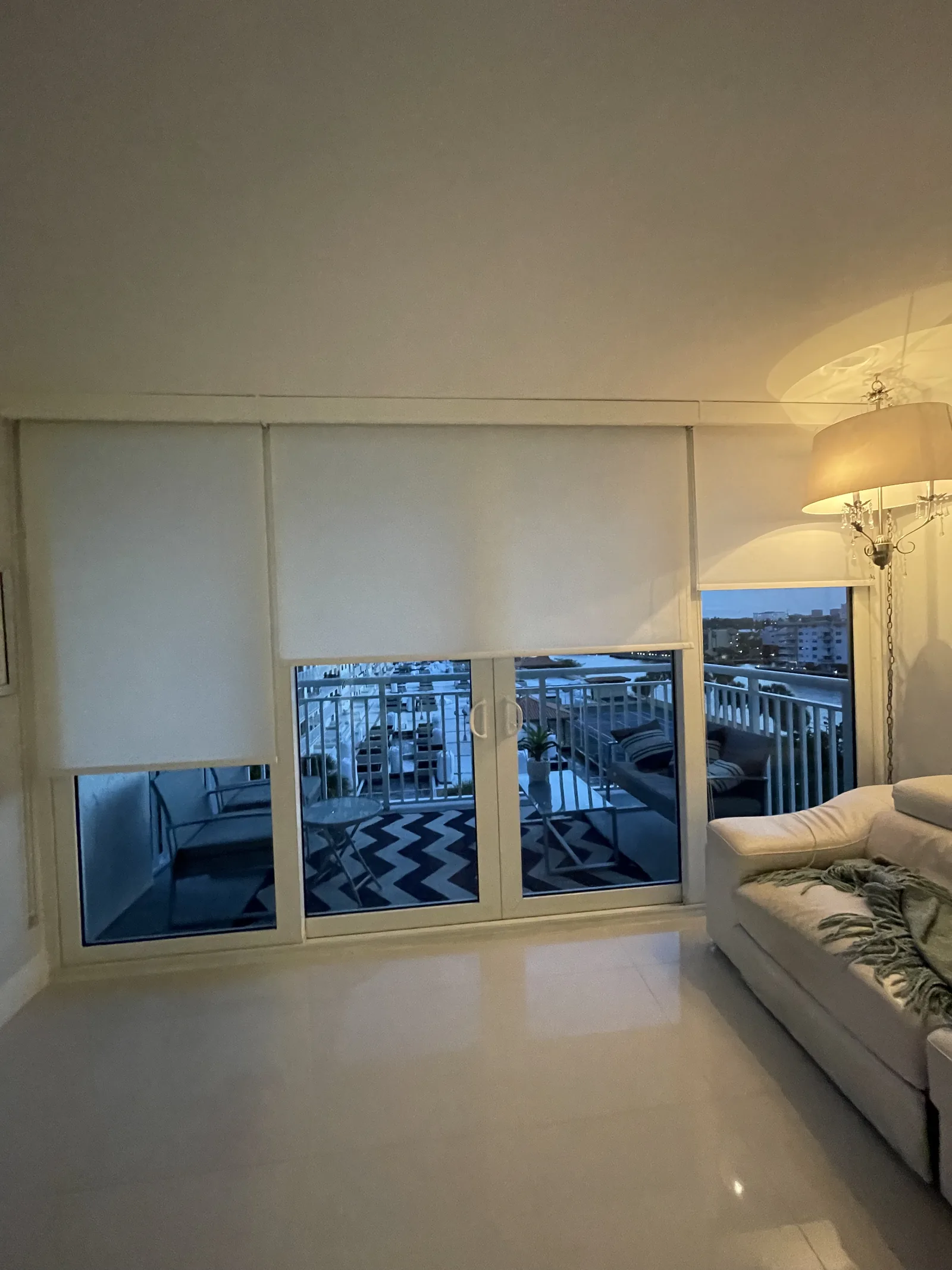 Light-filtering roller shades beside a patio slider