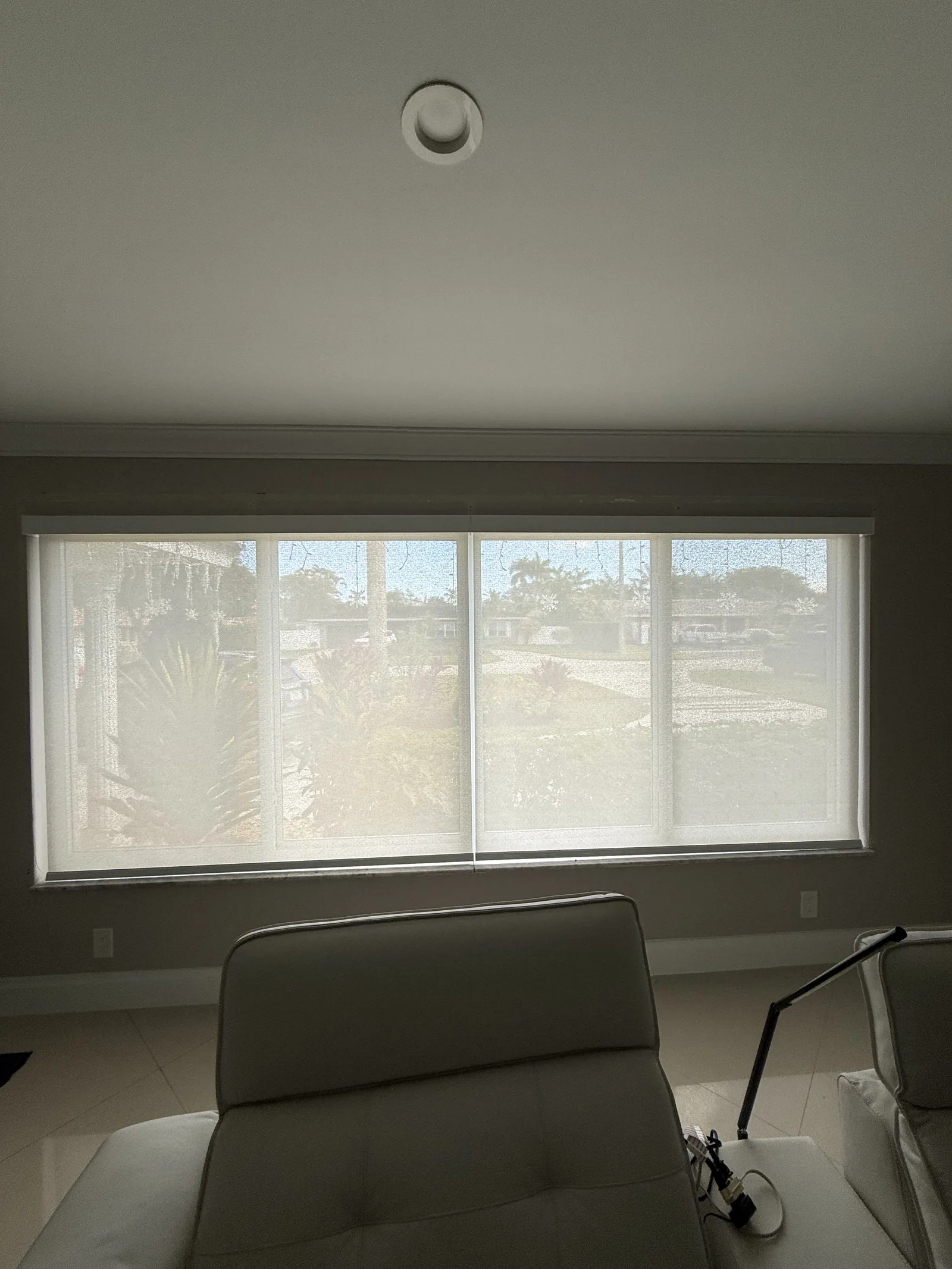 Light-filtering roller shade over a home-office window