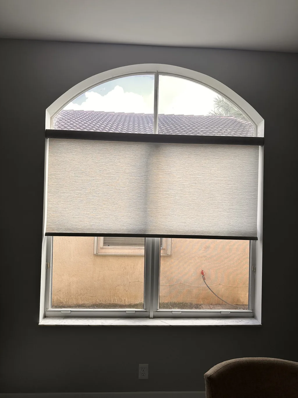 Roller light-filtering shade in a bright living room