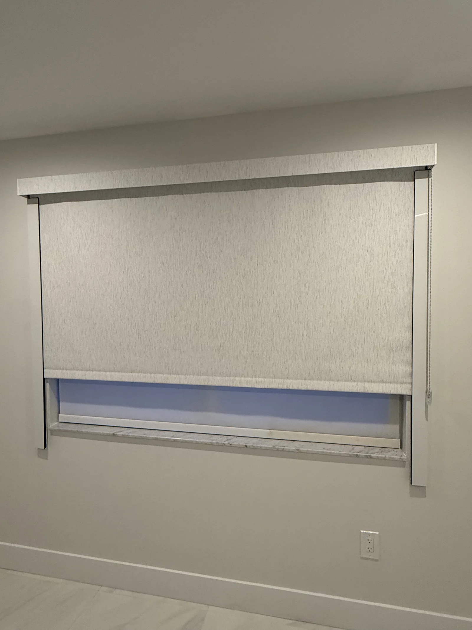 Roller shade sealed into side channels on a bedroom window