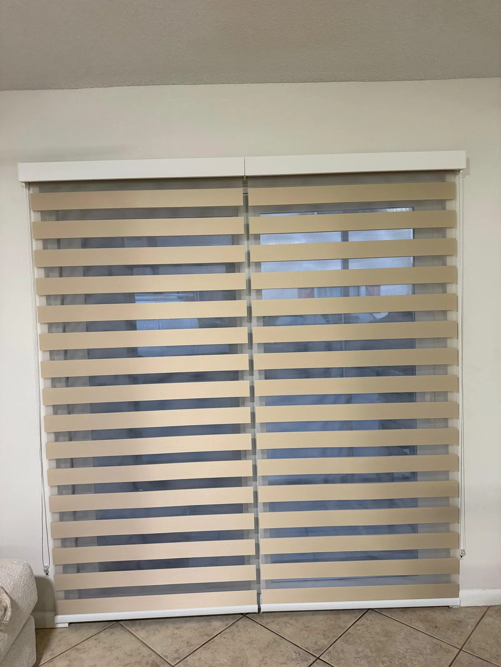 Zebra dimout shades on a wide sliding door