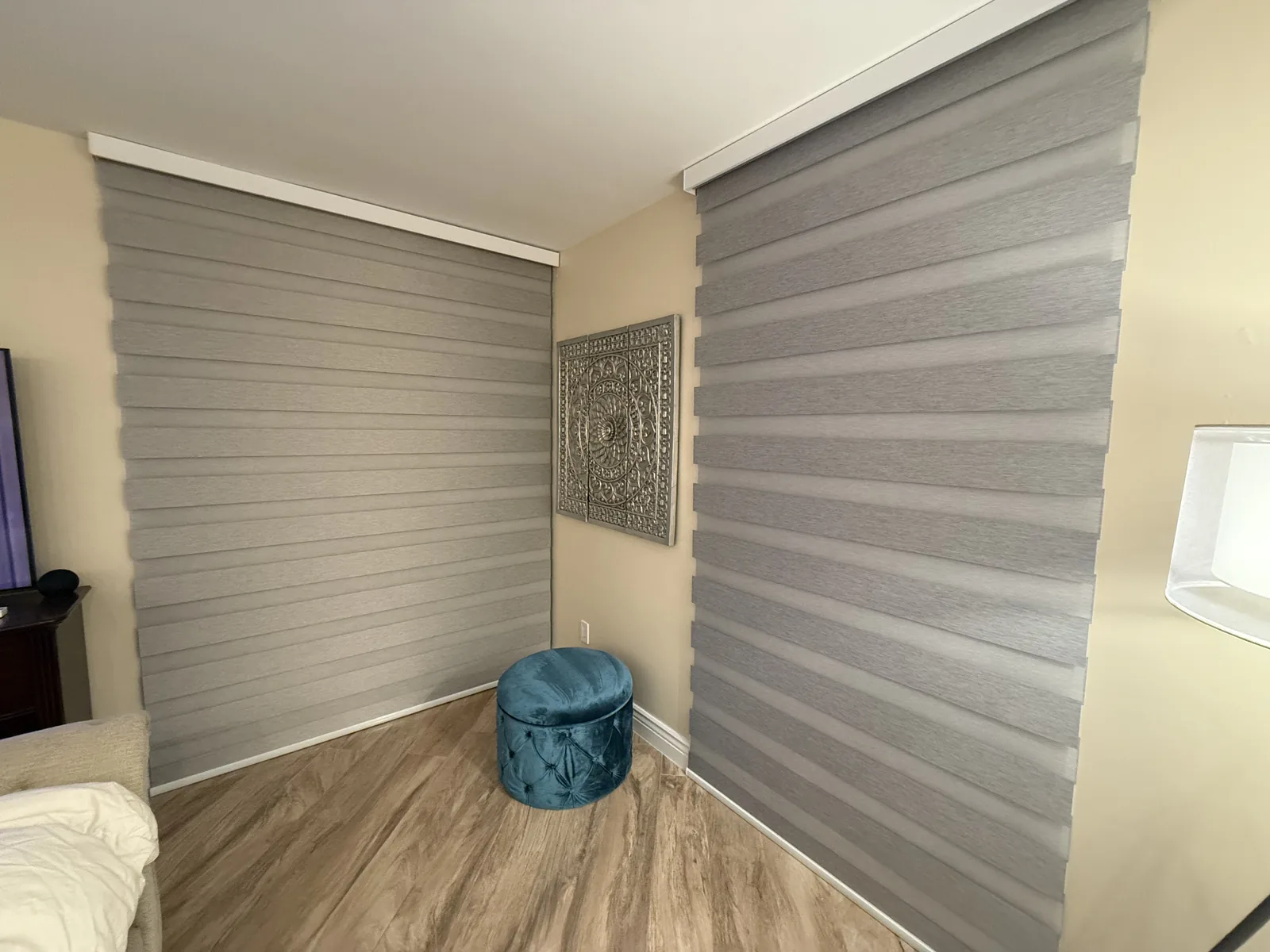 Zebra dimout shades wrapping a bedroom corner
