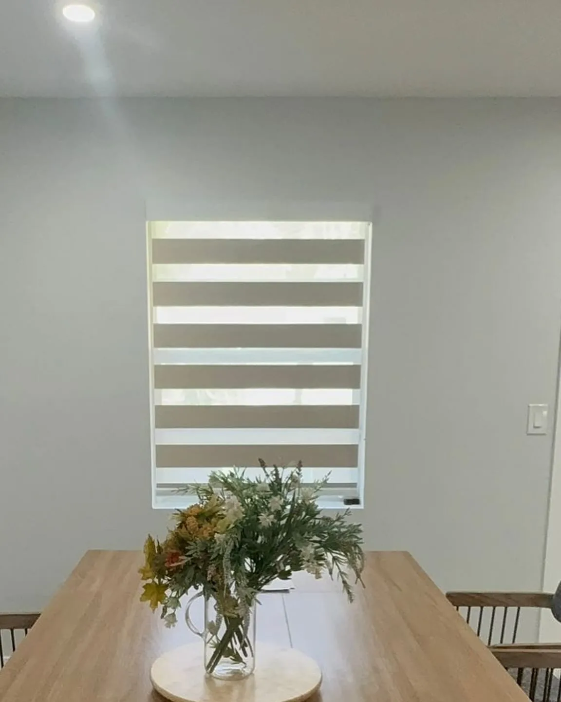 Zebra shade above a dining table